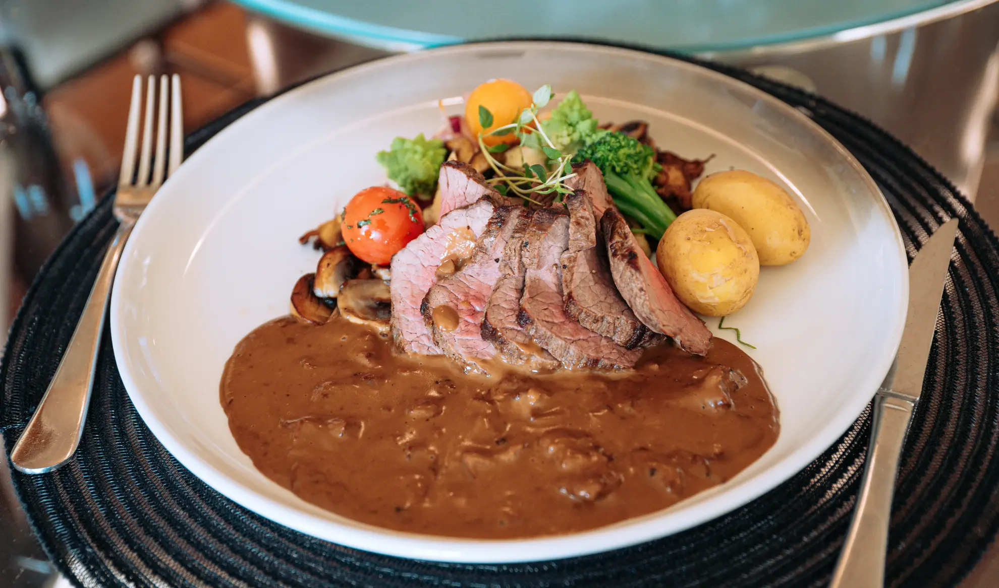 Locally sourced frilandsgris with a cognac sauce and seasonal vegetables